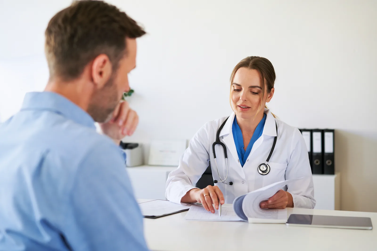Physician discussing care with a patient in a clinic