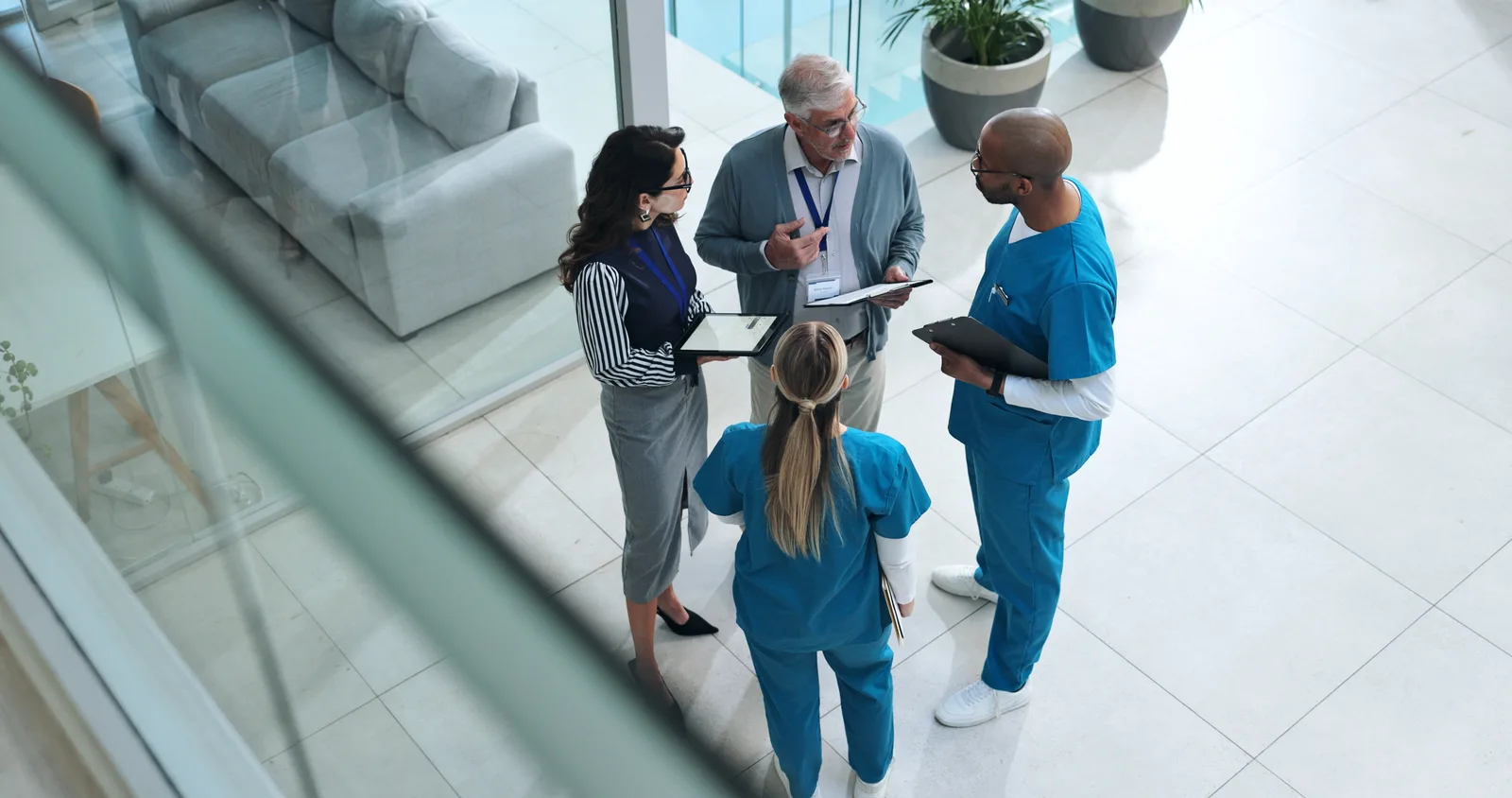 Clinical and administrative leaders collaborating in a hospital lobby